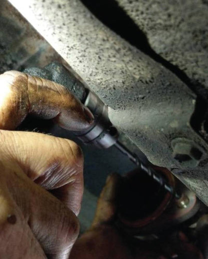 a man is working on a car's brake assembly